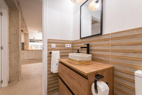 a bathroom with a sink and a mirror at K-DOCK by Nuka Homes in Jávea