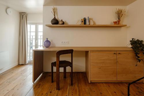 a wooden desk with a chair in a room at CENTRAL Hôtel La Rochelle Centre in La Rochelle