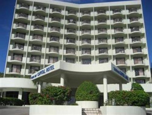 a large hotel building with a sign in front of it at Tumon Bay Capital Hotel in Tumon