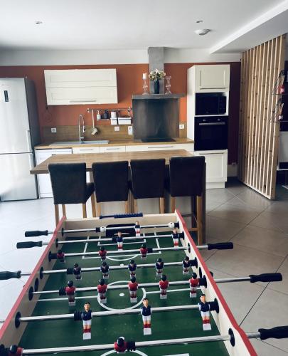 a pool table with balls on it in a kitchen at Chez Hélène et Jérémy in Montargis