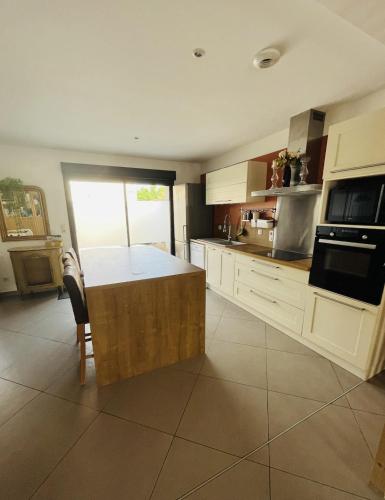 a kitchen with a island in the middle of it at Chez Hélène et Jérémy in Montargis