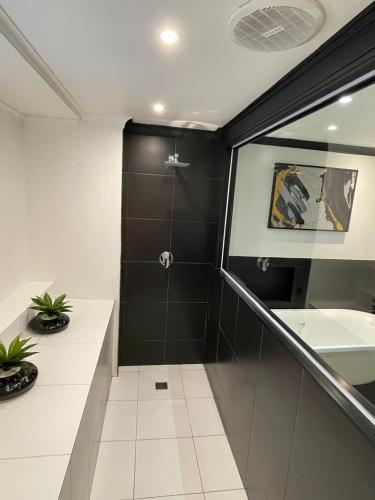 a bathroom with a shower and a sink at Knys-to-stay in Knysna