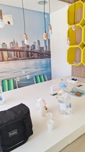 a table with a bag and cups on it at Up Hostel in Porto Alegre