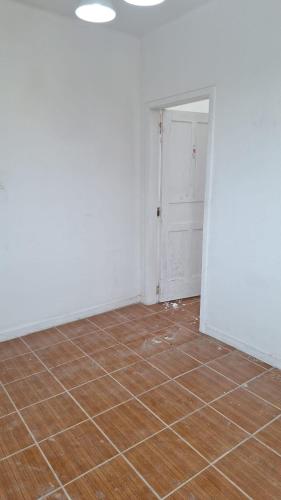 an empty room with a tile floor and a door at Up Hostel in Porto Alegre