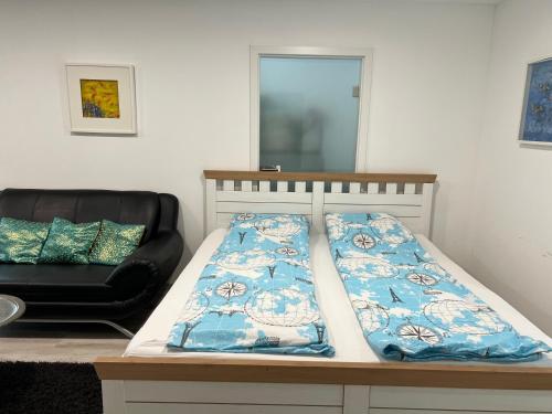 a bed and a chair in a room at EG-Souterrain Wohnung in Marburg an der Lahn