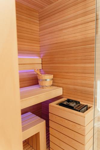 a sauna with wooden walls and a stove in it at Wine & Wellness in Villalta