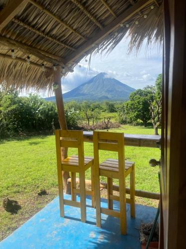a chair on a porch with a view of a mountain at Finca Aisa -Boutique bungalows in Ometepe island in Santa Cruz