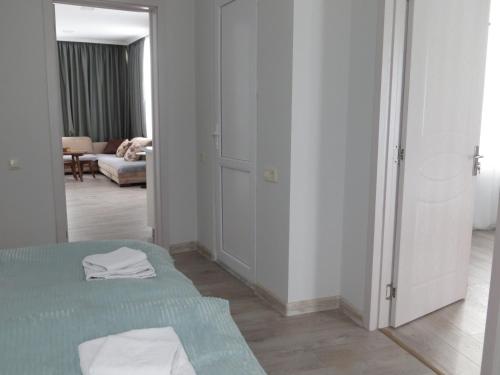 a white room with a bed and a mirror at Guesthouse Bacha & Lia in Mestia