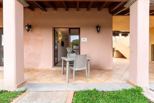 a patio with a table and chairs on it at Il Mirto Appartamenti, Ac e Wifi, Gallura in Vignola Mare