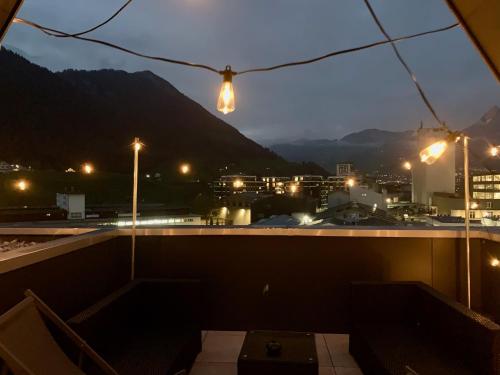 a view of a city at night with lights at Dora o wellness o mountainview o lake Lucerne in Ingenbohl