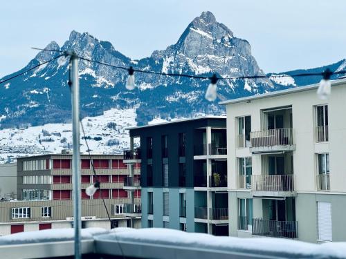 a view of some buildings with a mountain in the background at Dora o wellness o mountainview o lake Lucerne in Ingenbohl