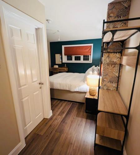 a bedroom with a bed and a bunk bed at The FightingCocks in Fordingbridge