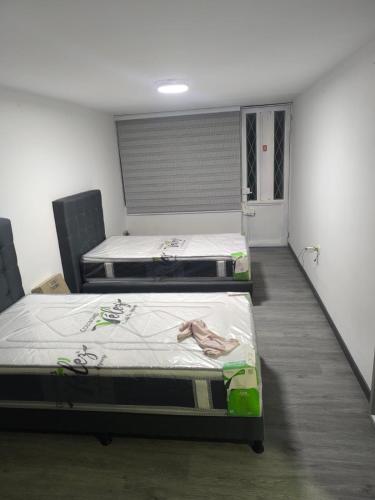 three mattresses in a room with two beds at Cálida Casa Zil&Li coliving Tunja in Tunja
