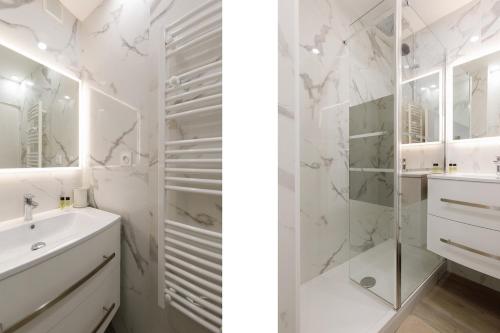 une salle de bain blanche avec un lavabo et une douche dans l'établissement Le Chataigner - Center - Parking - Clim - Wifi, à Cannes