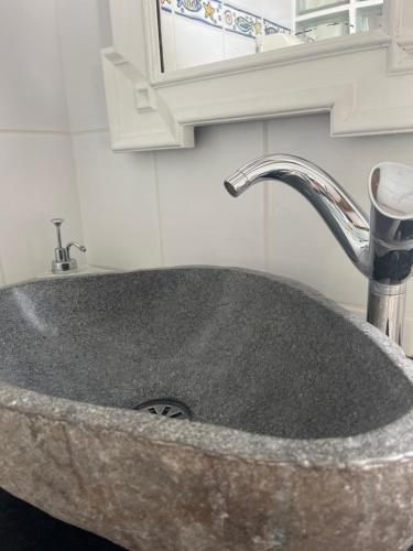 a granite sink with a faucet in a bathroom at Lucky Lemons Boutique Houses Madeira 1 in Calheta