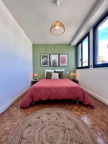 une chambre avec un grand lit avec une couverture rouge dans l'établissement Casa #1407 - T2 Climatisé avec Balcon - Hyper Centre, à Brive-la-Gaillarde