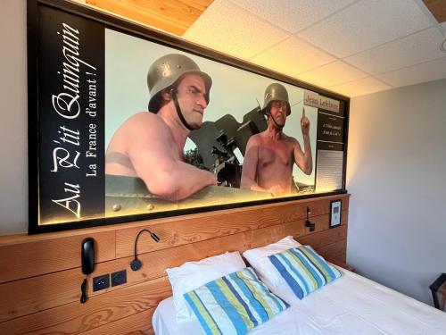 a sign above a bed with two men in a tub at au petit quinquin in Céaux