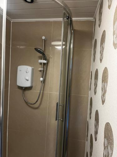 a shower with a glass door in a bathroom at Levy Nook 9 in Darlington