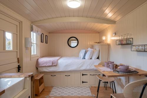 a bedroom with a bed and a table in a room at Walltree House in Brackley