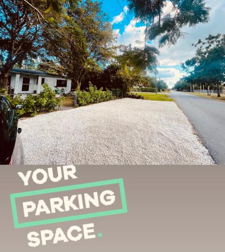 a driveway with a sign that reads your parking space at RV in the Little Jungle by Legnalife in Homestead