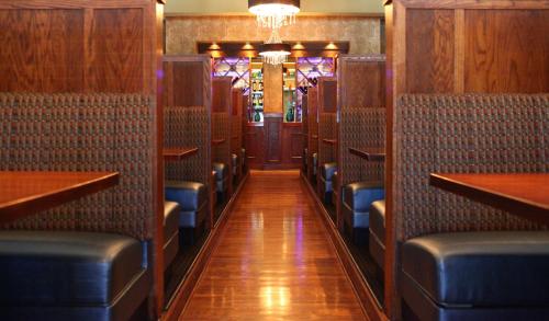 a corridor of a restaurant with chairs and tables at Hilton Garden Inn Des Moines Airport in Des Moines
