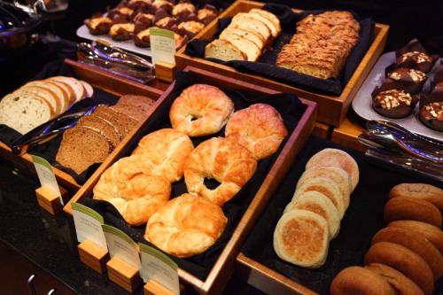 a display of different types of breads and pastries at Hilton Garden Inn Des Moines Airport in Des Moines