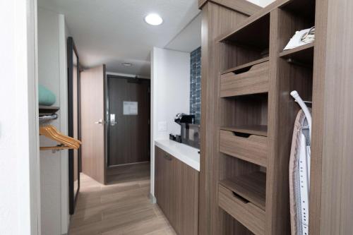 a bathroom with wooden shelves in a room at Hilton Garden Inn Des Moines Airport in Des Moines
