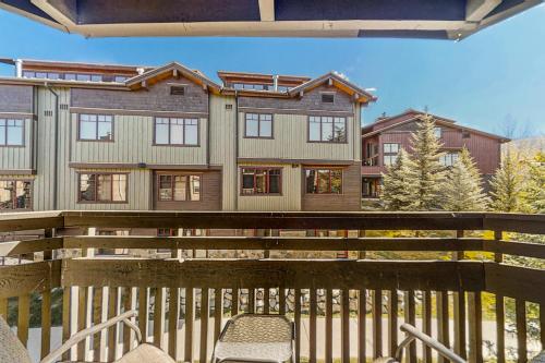a house with a wooden fence and a chair at The Lodge at Steamboat in Steamboat Springs