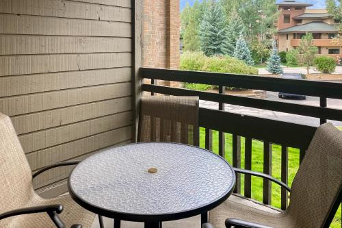 a table and two chairs on a balcony with a table at The Lodge at Steamboat in Steamboat Springs