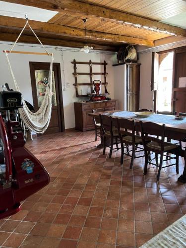 a dining room with a table and chairs and a camera at Villa Gorghe in San Severino Lucano
