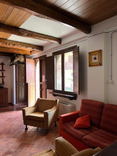 a living room with a couch and a chair at Villa Gorghe in San Severino Lucano