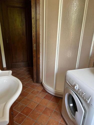a bathroom with a washing machine and a toilet at Villa Gorghe in San Severino Lucano