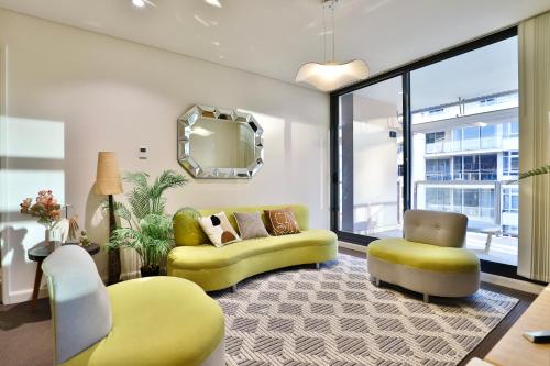 a living room with a yellow couch and a chair at Urban Oasis Residence - Views · Parking · Ease in Sydney