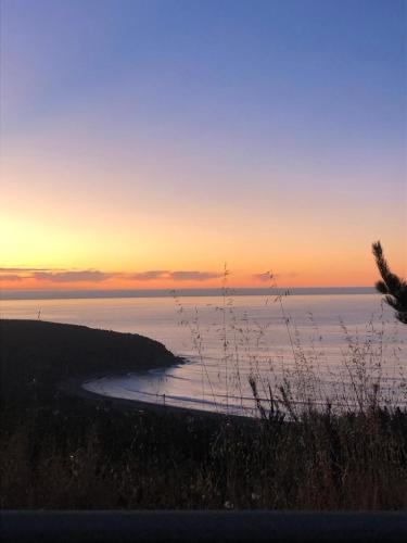 a view of the ocean at sunset with a beach at Casa Puertecillo in Puertecillo