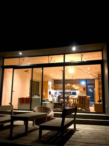 a patio with a bench and a living room at night at Casa Puertecillo in Puertecillo