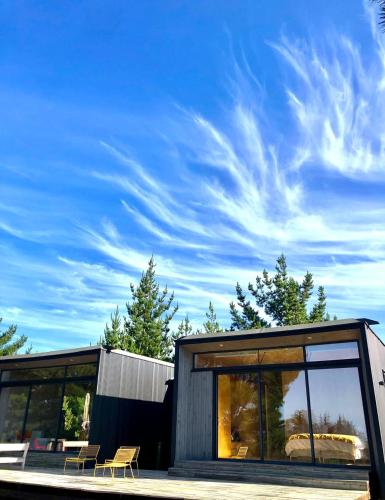 a modern house with large windows and a blue sky at Casa Puertecillo in Puertecillo