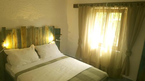 a bedroom with a large bed with a window at Tvrdic Honey in Grohote