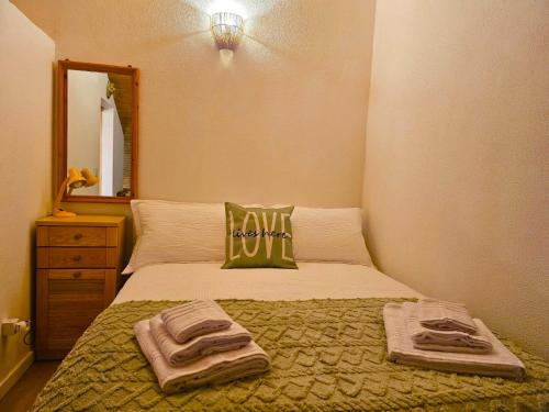 a bedroom with a bed with towels on it at Erbanova in Sila in Camigliatello Silano