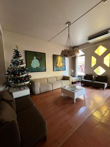 a living room with a christmas tree in it at Rio Maior Hotel in Rio Maior