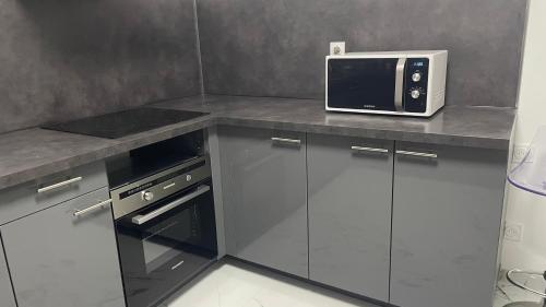 a kitchen with a counter with a microwave on it at maison individuelles pour 16 personnes in Lieusaint