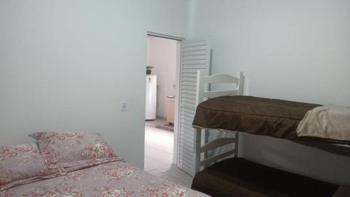 a bedroom with a bunk bed and a ladder at Sitio São Francisco de Assis in São Pedro de Alcântara