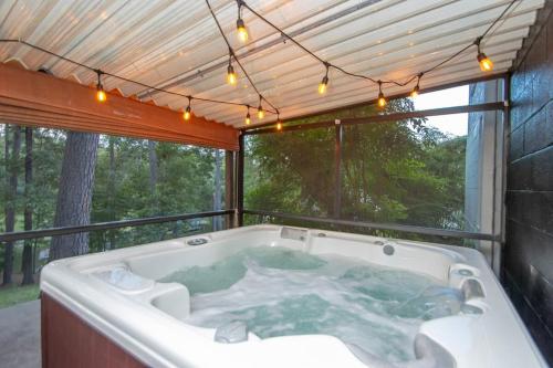een hot tub in een kamer met een groot raam bij Lakefront, Game Room, Hot Tub, Fire Pit in Hot Springs