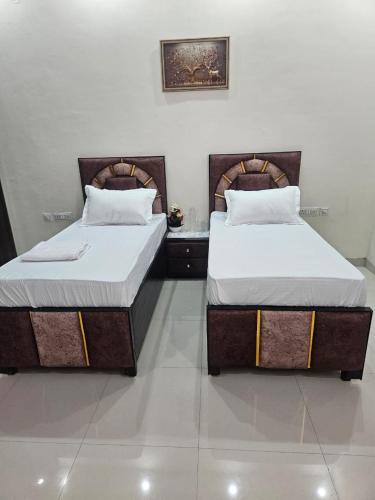 two beds sitting next to each other in a room at Ashirwaad 249 in Greater Noida