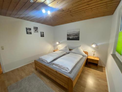 a bedroom with a bed and a wooden ceiling at Wutachtal 12 in Blumberg