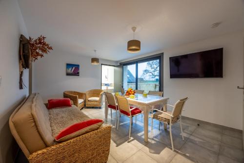 a living room with a table and a couch at LOGIS DU GRAND PIN in Saint-Martin-des-Entrées