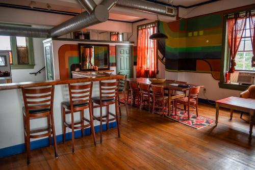 a colorful room with a bar with stools at Michie Hostel in Providence