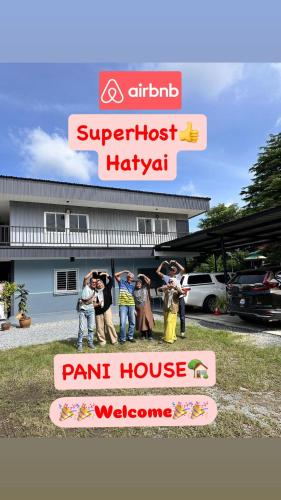 a group of people standing in front of a paint house at Pani House Hatyai 4 in Hat Yai