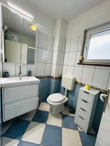 a bathroom with a toilet and a sink and mirror at Medulin - Romeo - Wohnung direkt am Meer in Medulin