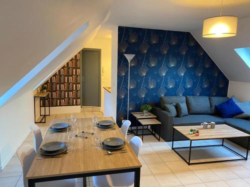 un salon avec une table et un canapé dans l'établissement Le Nid de Liais, à Cherbourg en Cotentin