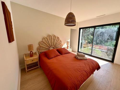 a bedroom with a large bed and a large window at Villa Provençale in Le Thor